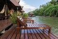 Empty wood chairs at riverside with mountain and fog behide Royalty Free Stock Photo