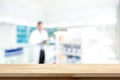 Empty wood counter top on blur pharmacy background Royalty Free Stock Photo