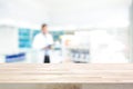 Empty wood counter top on blur pharmacy background Royalty Free Stock Photo