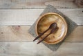 Empty wood dish with spoon and fork on wooden texture background Royalty Free Stock Photo