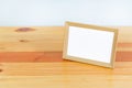 Empty wood photo frame on wooden table with copy space, picture