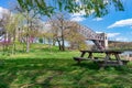 Empty Picnic Table during Spring along the East River on Randalls and Wards Islands of New York City with the Hell Gate Bridge in