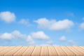 Empty wood plank table top with blue sky and clouds with blur background - For product display. Royalty Free Stock Photo