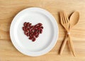 Empty wood plate with fork spoon and decorate red bean on white dish Royalty Free Stock Photo