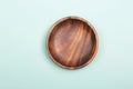 Empty wood plate on mint background