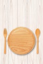 Empty wood plate with spoon fork on wood table