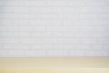 Empty wood plate top table on gray brick background.