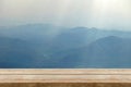 Empty wood table background with wooden table top. Bokeh mountain view