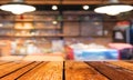 Empty wood table and Coffee shop blur background with bokeh imag Royalty Free Stock Photo