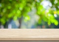 Empty wood table over blurred trees with bokeh background Royalty Free Stock Photo