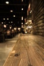 Empty wood table top of bar with blur of cafe restaurant in dark Royalty Free Stock Photo