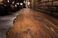 Empty wood table top of bar with blur of cafe restaurant in dark Royalty Free Stock Photo