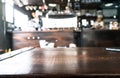 Empty wood table top with blur of abstract coffee shop or cafe