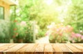 Empty wood table top on blur abstract green from garden