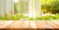 Empty wood table top on blur abstract green from garden