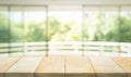 Empty wood table top on blur abstract green garden from window Royalty Free Stock Photo