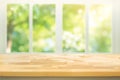 Empty wood table top on blur abstract green garden from window view Royalty Free Stock Photo