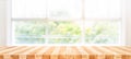 Empty wood table top on blur abstract green garden from window view in the morning. For montage product display or design key Royalty Free Stock Photo
