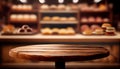 Empty wood table top on blur bakery shop or cafe restaurant with abstract bokeh background Royalty Free Stock Photo