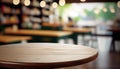 Empty wood table top on blur bakery shop or cafe restaurant with abstract bokeh background Royalty Free Stock Photo