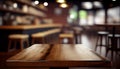 Empty wood table top on blur bakery shop or cafe restaurant with abstract bokeh background Royalty Free Stock Photo