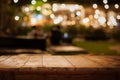 Empty wood table top and blur of cafe restaurant in dark night background Royalty Free Stock Photo