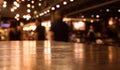 Empty wood table top on blur cafe restaurant in dark night with light background/selective focu Royalty Free Stock Photo