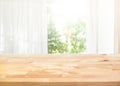 Empty of wood table top on blur of curtain with window view green from garden background Royalty Free Stock Photo