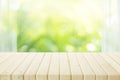 Empty of wood table top on blur of curtain with window view green from tree garden background Royalty Free Stock Photo