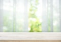 Empty of wood table top on blur of curtain with window view green from tree garden Royalty Free Stock Photo