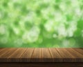 Empty of wood table top on blur of fresh green abstract from garden backgrounds.For montage product display or key Royalty Free Stock Photo