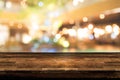 Empty wood table top and blur of night pub or restaurant background/selective Royalty Free Stock Photo