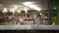 Empty wood table top and blur of night pub or restaurant background selective focus