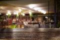 Empty wood table top and blur of night pub or restaurant background/selective focused. Royalty Free Stock Photo