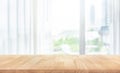 Empty of wood table top on blur of white curtain with window view background Royalty Free Stock Photo