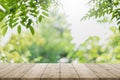 Empty wood table top and blurred green tree in the park garden background - can used for display or montage your products Royalty Free Stock Photo