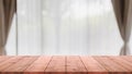 Empty wood table top and blurred living room in home interior with curtain window background. - can used for display or montage Royalty Free Stock Photo