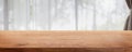 Empty wood table top and blurred living room in home interior with curtain window background. - can used for display or montage Royalty Free Stock Photo