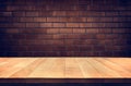 Empty wood table top with Brown brick wall background.