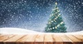 Empty wood table top with christmas tree and snowfall in sky Royalty Free Stock Photo