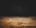 Empty wood table top counter on dark wall background