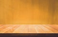 Empty wood table top counter on dark yellow wall background.For create product display or design key visual Royalty Free Stock Photo