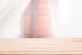 Empty of wood table top on defocuced of curtain window and wooden house sunlight.