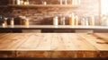 empty wood table top in front of bar counter top with blurred kitchen shelves and bottles Royalty Free Stock Photo