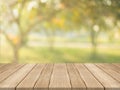 Empty wood table top on nature green blurred background at garden,space for montage show products