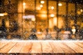 Empty wood table top with snowfall and bokeh cafe restaurant Royalty Free Stock Photo