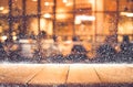 Empty wood table top with snowfall and bokeh cafe restaurant Royalty Free Stock Photo