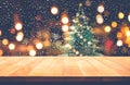 Empty wood table top with snowfall and cafe restaurant in night Royalty Free Stock Photo