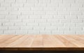 Empty wood table top with white brick wall background. Royalty Free Stock Photo