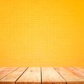 Empty wood table top with yellow brick wall background.For create product display or design key visual Royalty Free Stock Photo